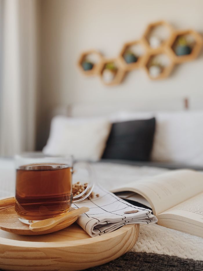 Warm and inviting São Paulo bedroom scene with tea and book, perfect for relaxation.